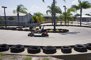 Picture of Andretti theme park where a child is racing go-karts against others for fun.