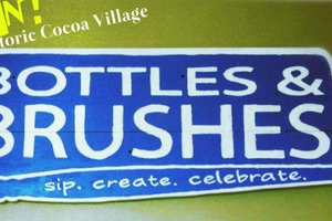 picture of Bottles and rushes advertisement. Sip. Create. Celebrate.