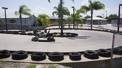 Picture of Andretti theme park where a child is racing go-karts against others for fun.
